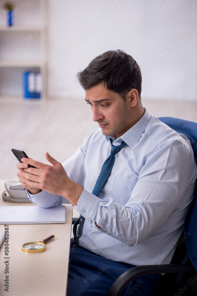Young male employee working in the office Young male employee working in the office