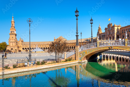 Morning view of the portico, tower and small lake at the Plaza de Espana, or Spanish Square, in Seville, Spain. 