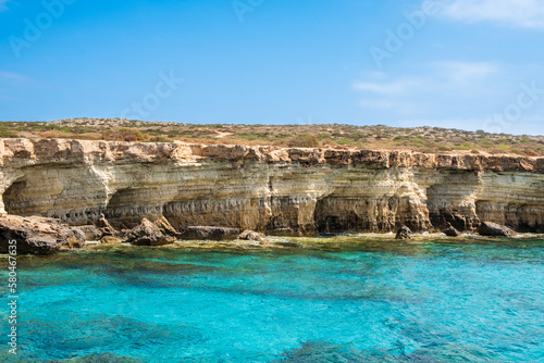 Sea caves near Ayia Napa in Cyprus. Natural rock formation famouse for cliff jumping into clear water. Dramatic coastline between Agia Napa and Cavo Greco National park