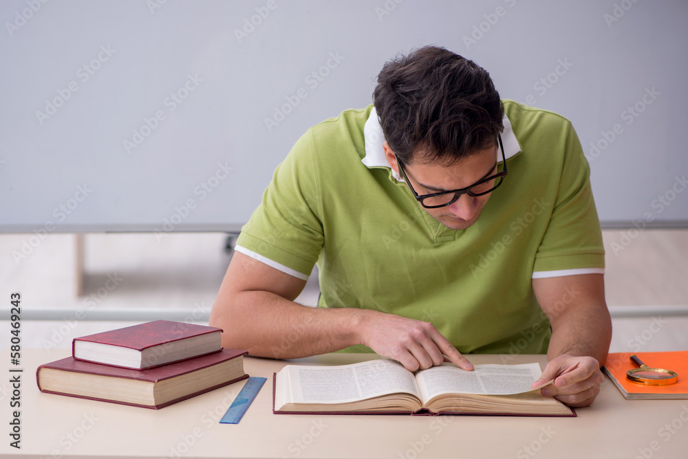 Young male student sitting in the classroom Young male student sitting in the classroom