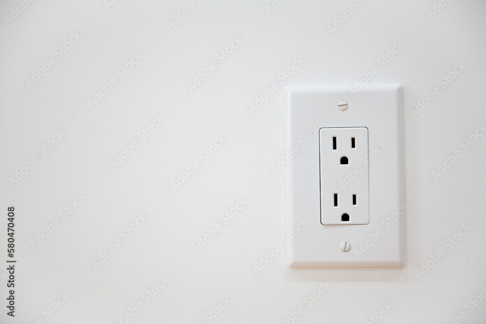 White Electrical Outlet and Wall Plate at the white wall White Electrical Outlet and Wall Plate at the white wall