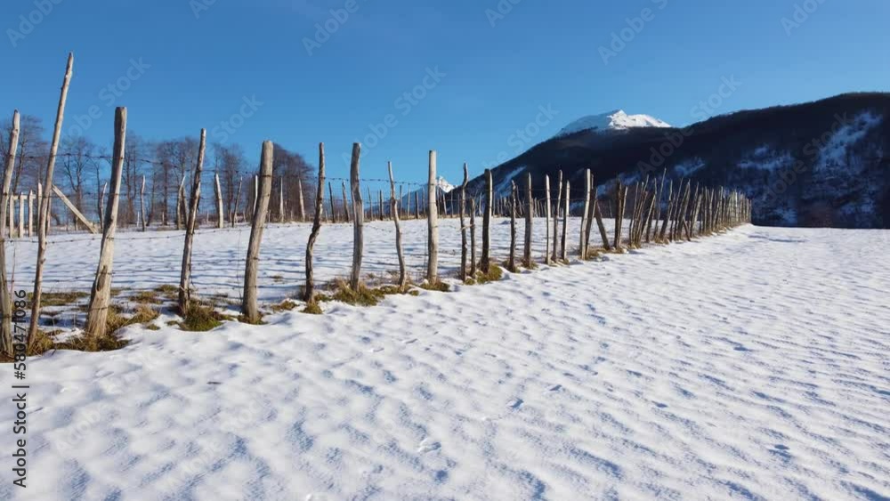 Barbed wire against white snow. Rusty metal wire fence, aerial drone video. Barbed wire against white snow. Rusty metal wire fence, aerial drone video.