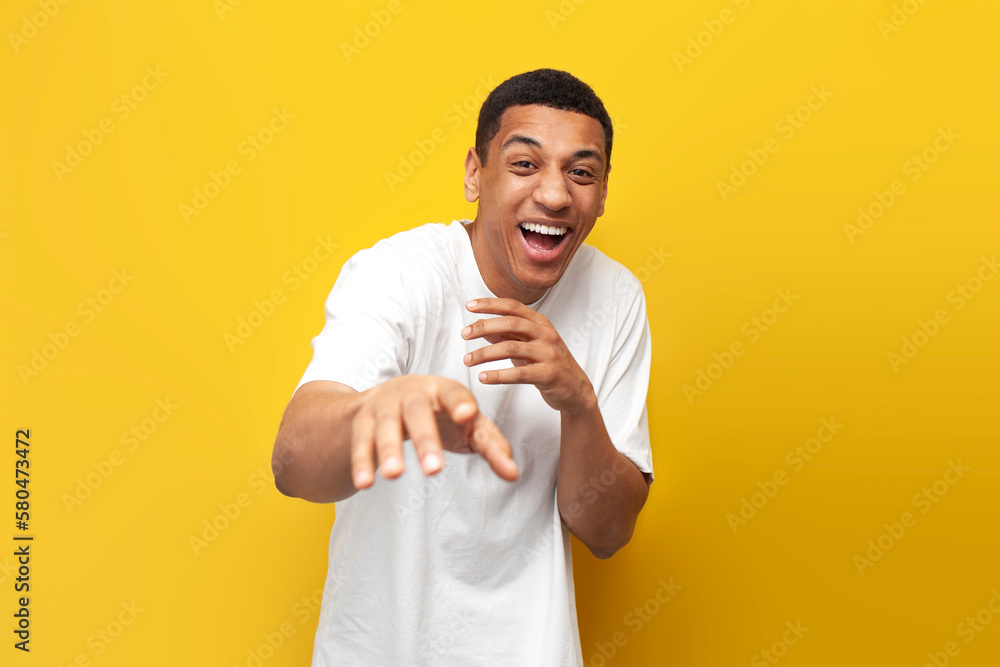 young funny guy african american in white t-shirt mocking and joking showing his hands to the camera young funny guy african american in white t-shirt mocking and joking showing his hands to the camera
