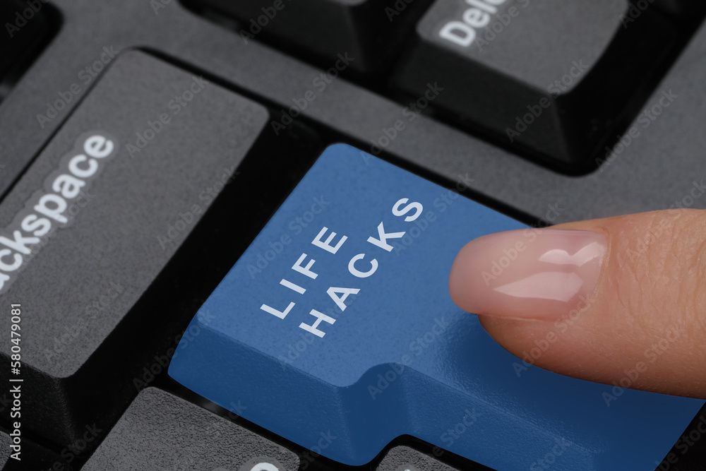 Woman pressing blue button with words Life Hacks on computer keyboard, closeup Woman pressing blue button with words Life Hacks on computer keyboard, closeup