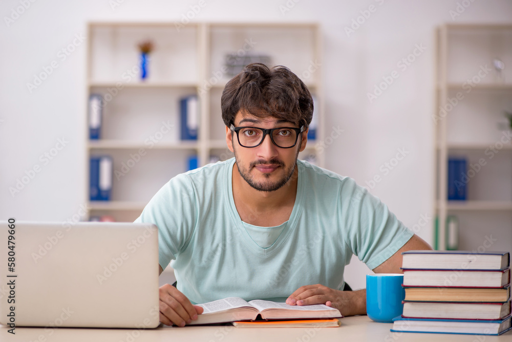 Young male student preparing for exams in the classroom Young male student preparing for exams in the classroom
