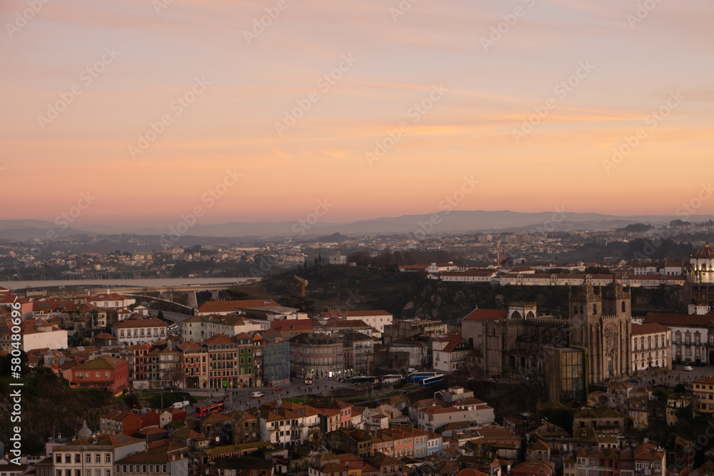 A view across the medieval city of Porto, Portugal at sunset looking towards the Cathedral 