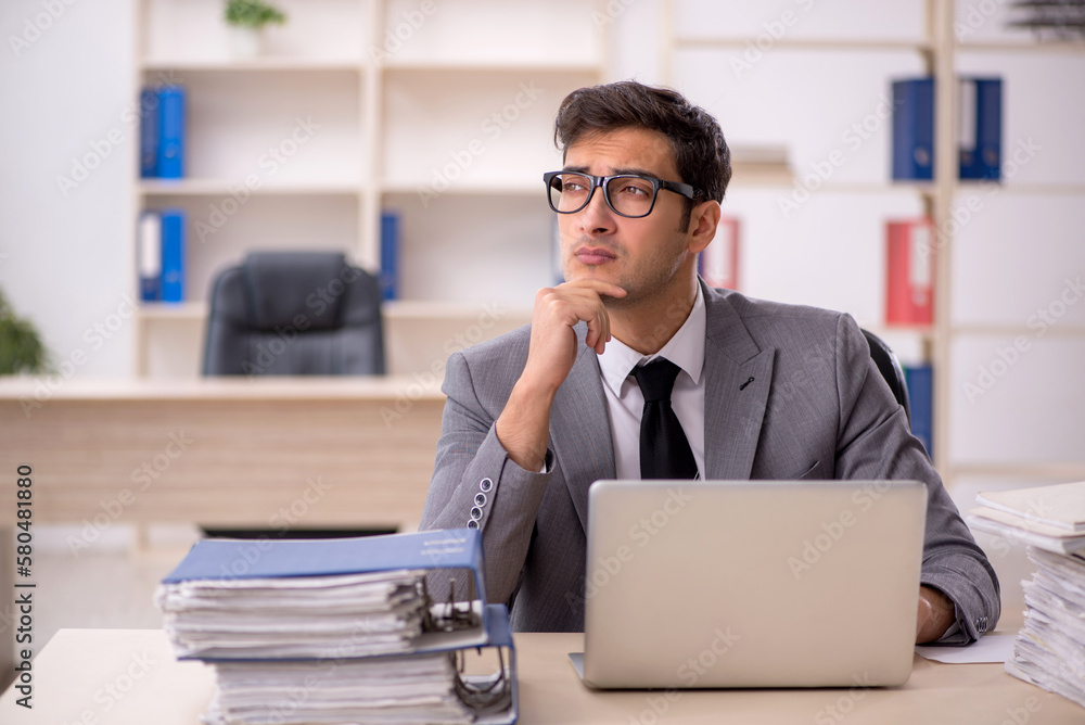 Young male employee working in the office Young male employee working in the office