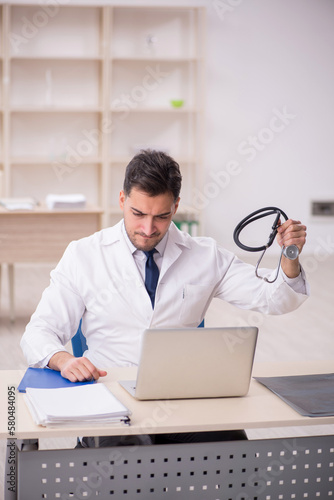 Young male doctor working at the hospital