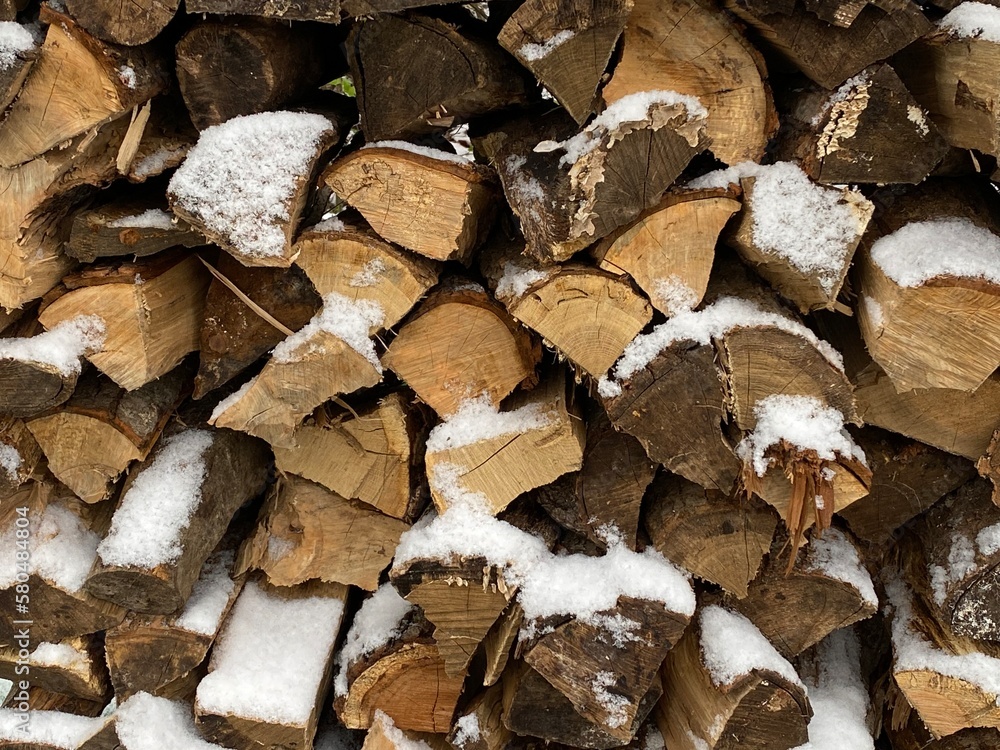 stack of firewood with dusting of snow stack of firewood with dusting of snow