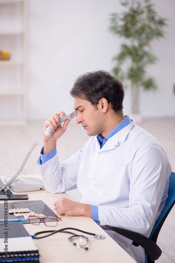 Young male doctor being tired after night shift Young male doctor being tired after night shift