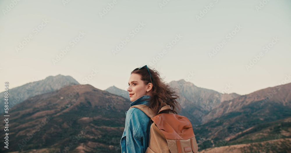 Young caucasian girl going for an adventure, hiking in beautiful mountains, having an active vacation - zennism, freedom, recreational pursuit concept 