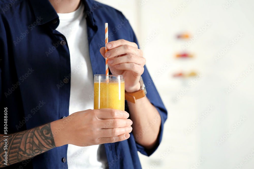 Man with delicious smoothie at home, closeup. Space for text Man with delicious smoothie at home, closeup. Space for text
