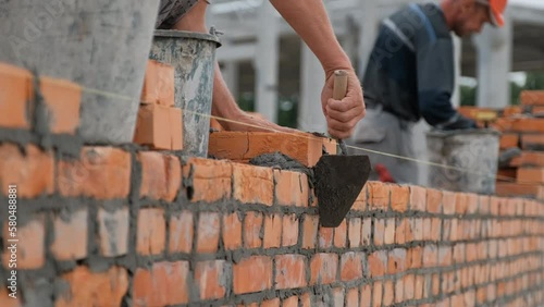 builders are building a brick wall photo