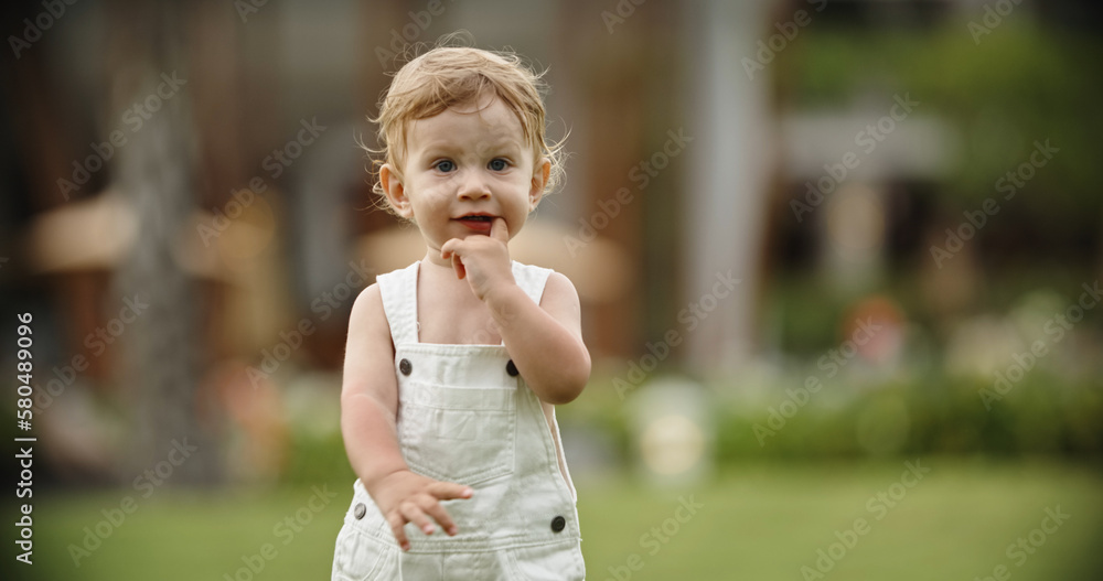 Naklejka premium little lovely boy walk in the park. Portrait of cute little blondie baby, blue eyes boy. Copy space