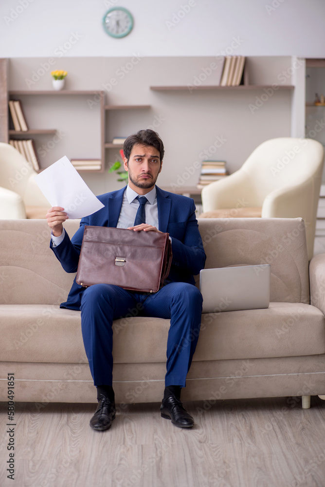 Young male employee working from home during pandemic Young male employee working from home during pandemic