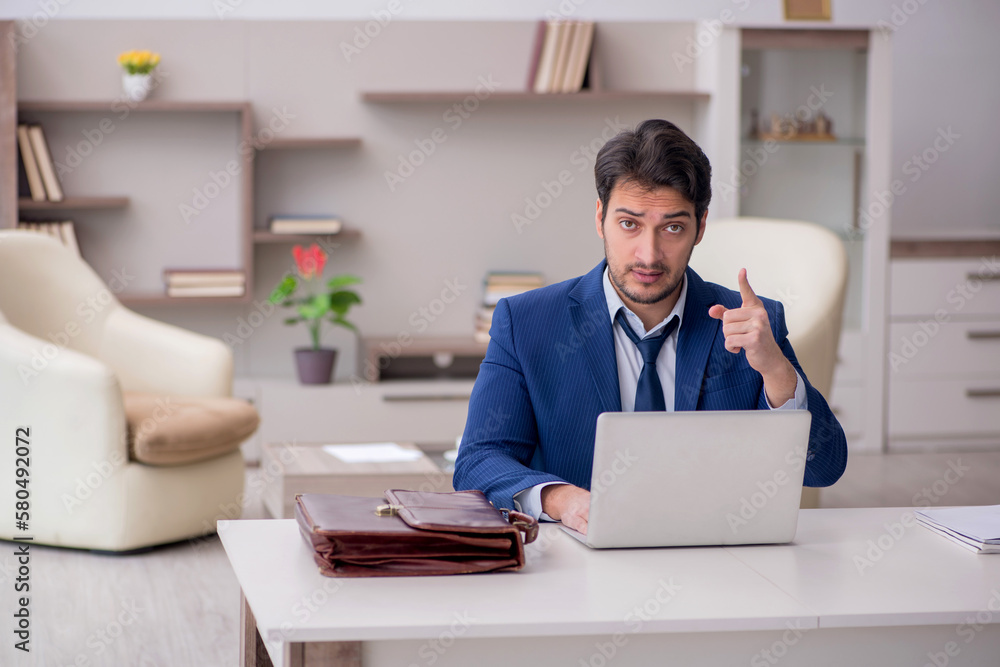 Young male employee working from home during pandemic Young male employee working from home during pandemic