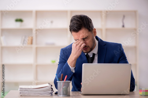 Young male employee working in the office