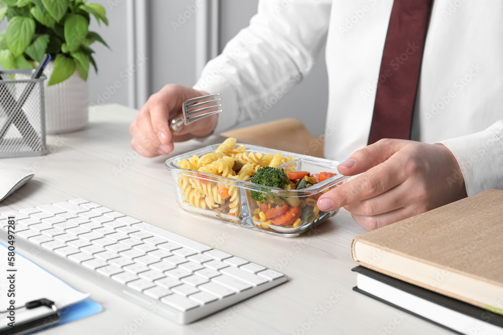 Office employee having business lunch at workplace, closeup Office employee having business lunch at workplace, closeup