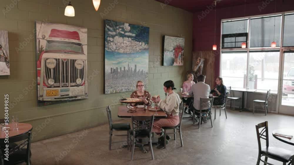 Two female friends enjoyed a small local restaurant where they shared delicious food while appreciating the friendly and quality service. Two female friends enjoyed a small local restaurant where they shared delicious food while appreciating the friendly and quality service.