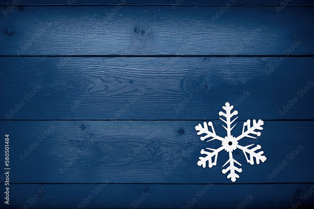 Fototapeta premium paper snowflake figure on blue color wooden background