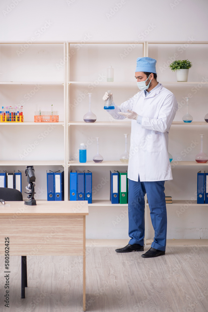 Young male chemist working at the lab Young male chemist working at the lab