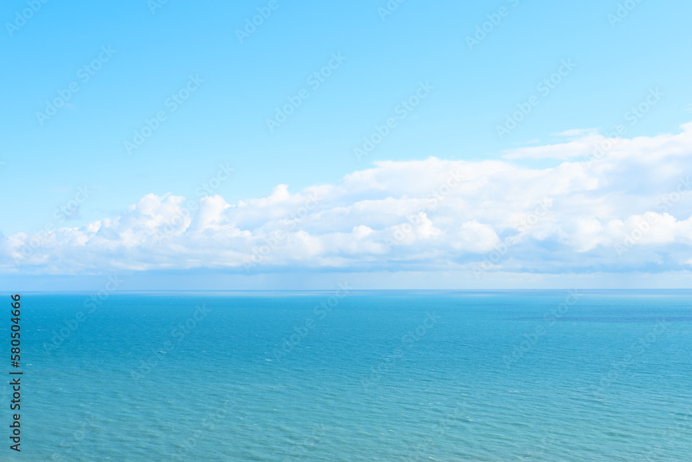 Nature background with blue sea against cloudy sky