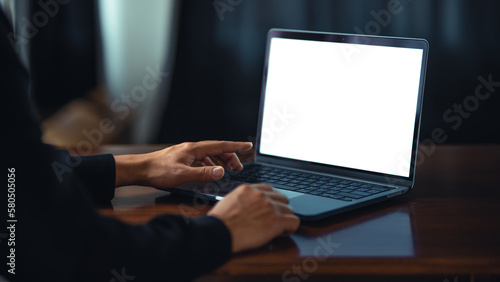 Obraz na płótnie Man using laptop with white blank screen mockup