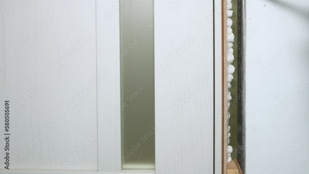 Foaming cracks in the door frame with mounting foam. Construction and repair. Installation and fastening of a wooden frame. Foaming cracks in the door frame with mounting foam. Construction and repair. Installation and fastening of a wooden frame.