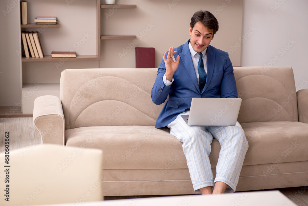 Young male employee working from home during pandemic Young male employee working from home during pandemic