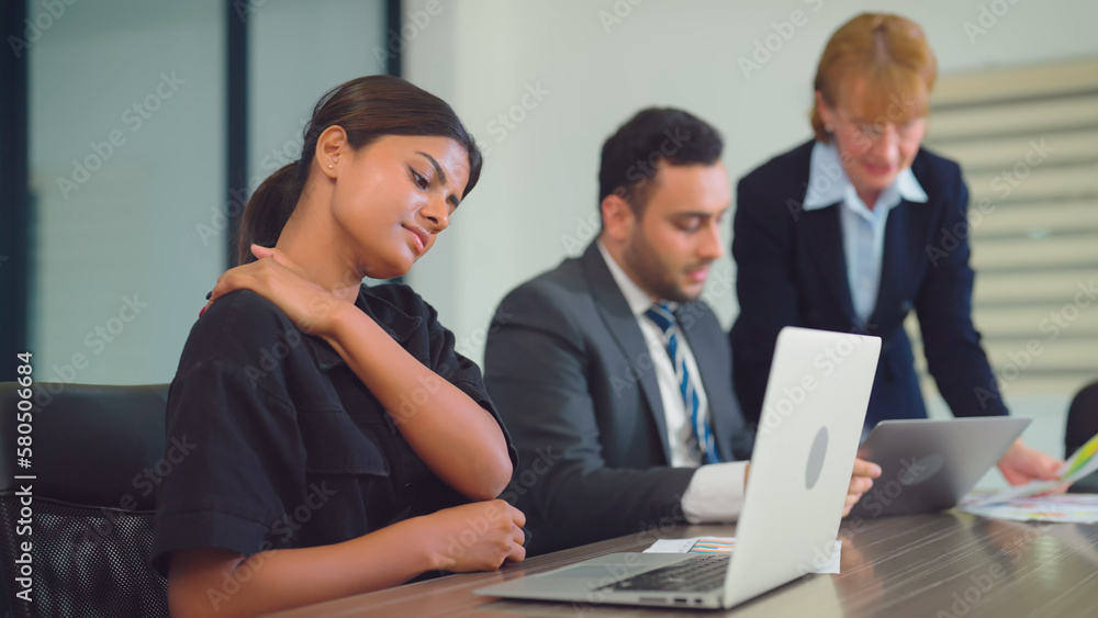 Tired young indian woman working at office. She having painful head feelings due to computer overwork or sedentary working lifestyle. Tired young indian woman working at office. She having painful head feelings due to computer overwork or sedentary working lifestyle.