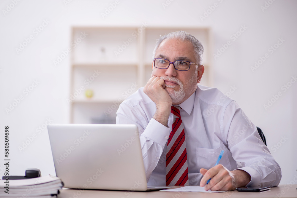 Old male employee and too much work in the office Old male employee and too much work in the office