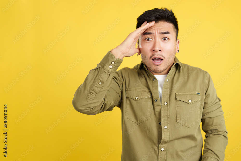Shocked chinese man gesturing that he is forgetting something Shocked chinese man gesturing that he is forgetting something