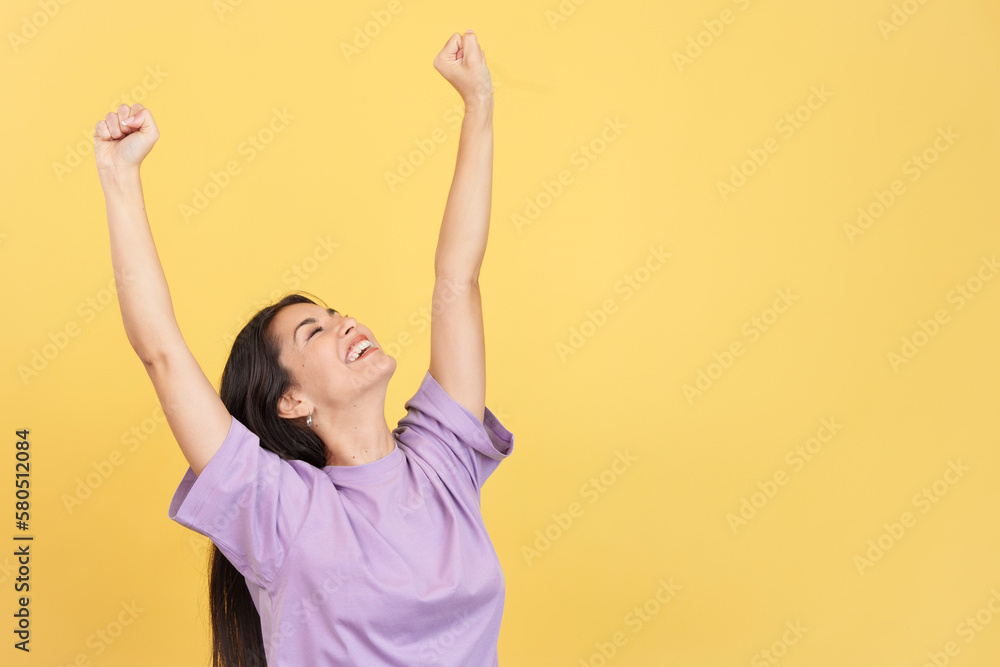 Happy caucasian woman celebrating while raising arms Happy caucasian woman celebrating while raising arms
