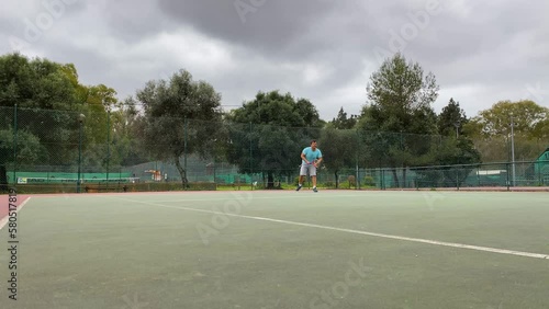 Sportive man Playing Professional Tennis On The Tennis Court , Sunny Day photo