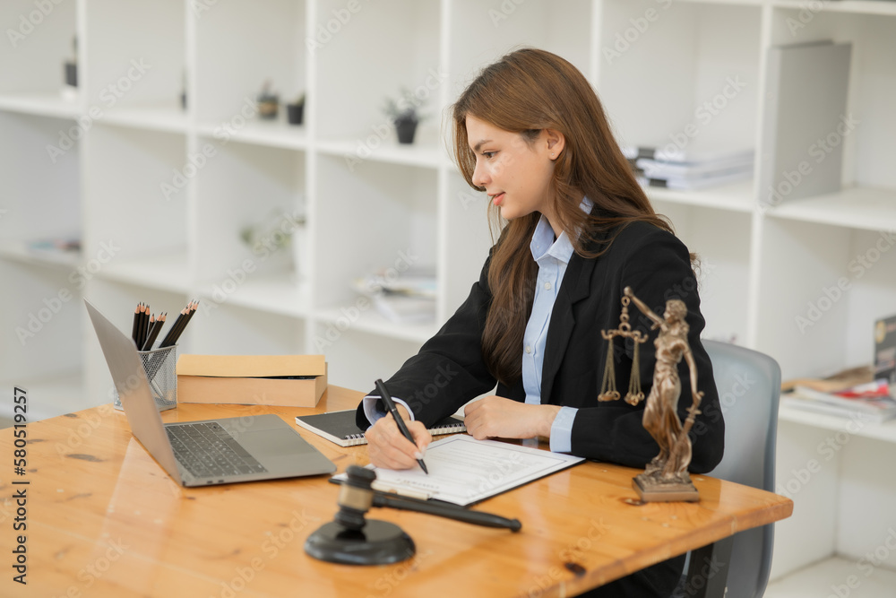 Female lawyer working at client's office discussing documents Female lawyer working at client's office discussing documents