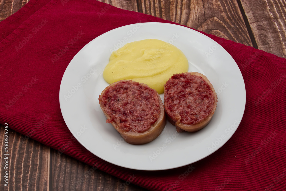 Slices of traditional Italian sausage Zampone di Modena with mashed potatoes. Slices of traditional Italian sausage Zampone di Modena with mashed potatoes.