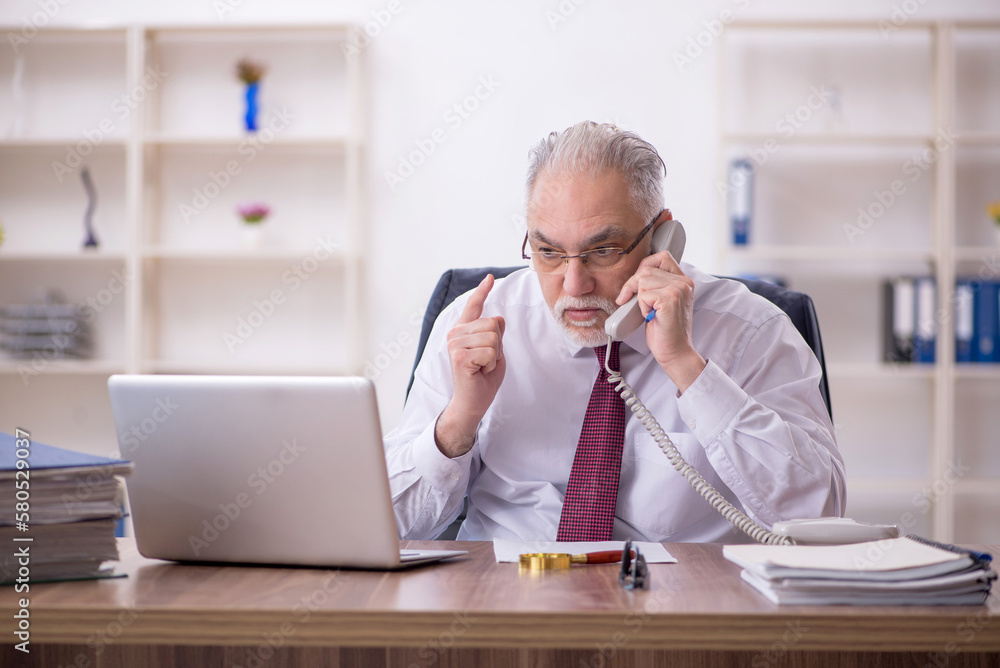 Old male employee and too much work in the office Old male employee and too much work in the office