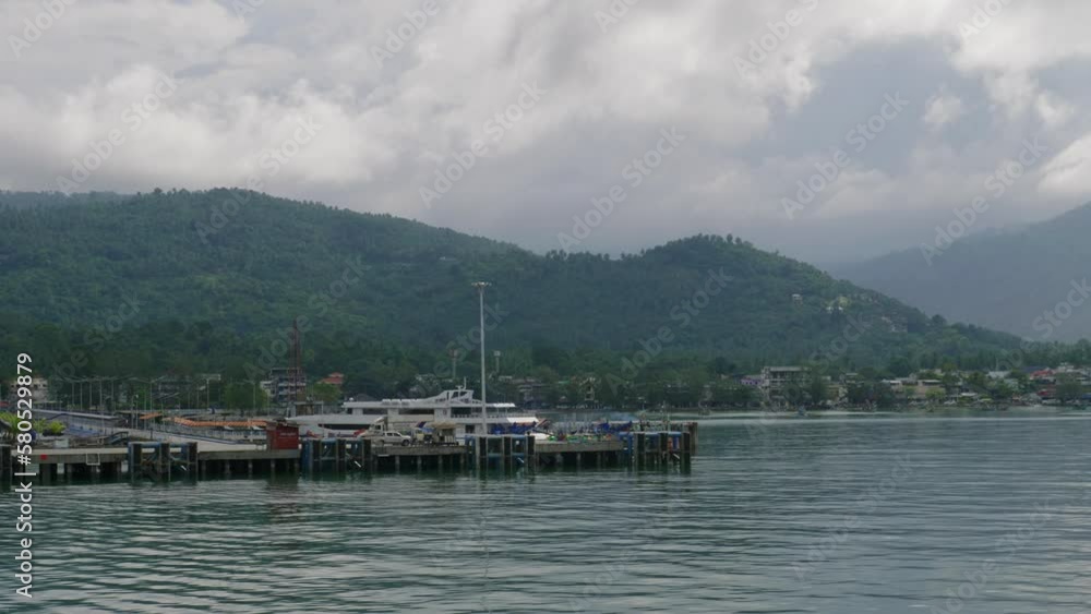 Koh Samui Thailand on overcast cloudy day, view from ferry boating away Koh Samui Thailand on overcast cloudy day, view from ferry boating away