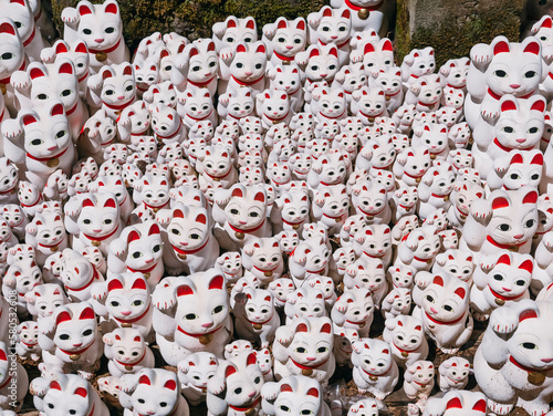 Lucky cat dolls in Temple Japan culture Maneki neko © VTT Studio