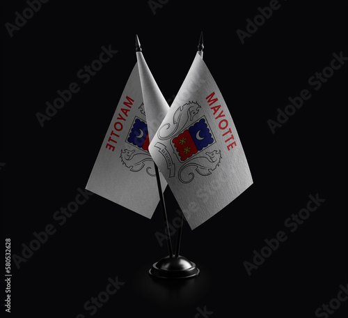 Small national flags of the Mayotte on a black background photo