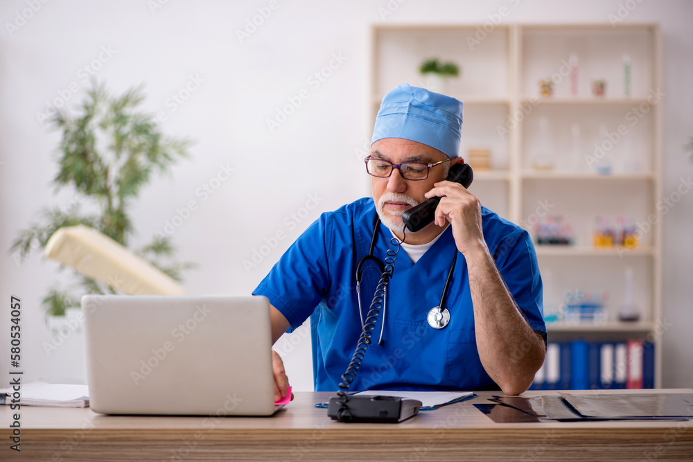 Old male doctor in telemedicine concept Old male doctor in telemedicine concept