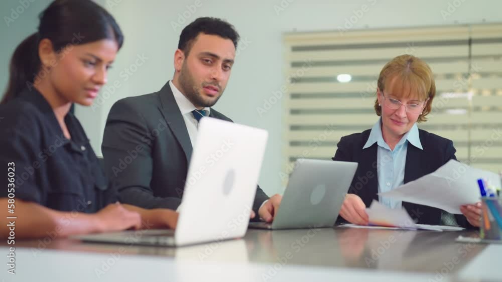 Group of diverse business people working together at modern office. They discuss business projects together. Group of diverse business people working together at modern office. They discuss business projects together.