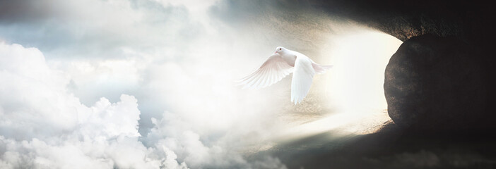 Jesus Christ crucifixion death and resurrection and easter dove flying out of a stone tomb concept
