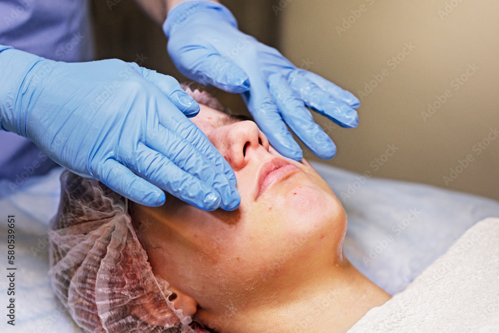 doing cosmetic therapeutic massage for a young face. horizontal doing cosmetic therapeutic massage for a young face. horizontal