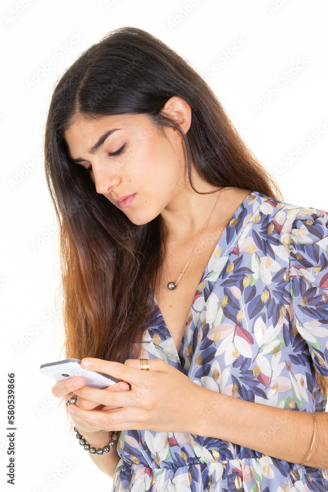 cute brunette woman with long dark hair holding texting using cell mobile phone on white background cute brunette woman with long dark hair holding texting using cell mobile phone on white background