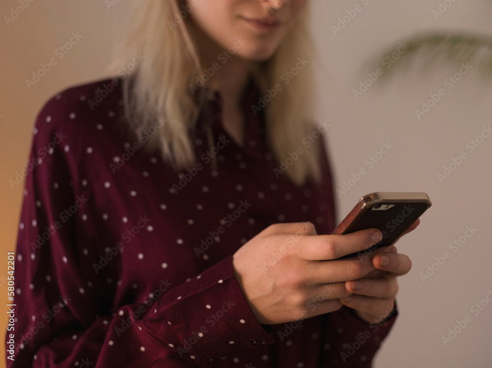 Midsection of woman using mobile phone at home Midsection of woman using mobile phone at home