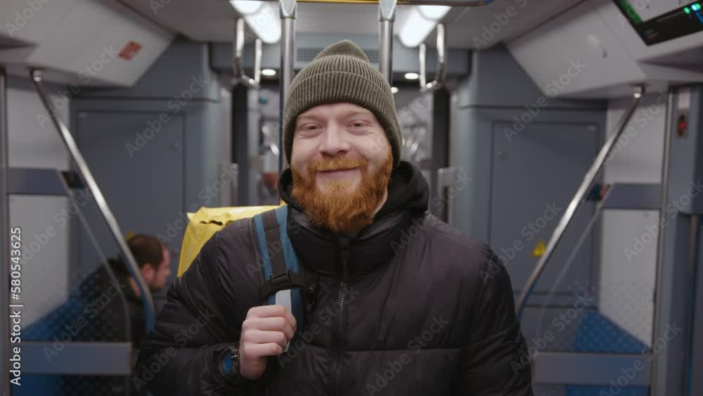 Smiling portrait of a delivery man in a subway car. Video in high quality Smiling portrait of a delivery man in a subway car. Video in high quality