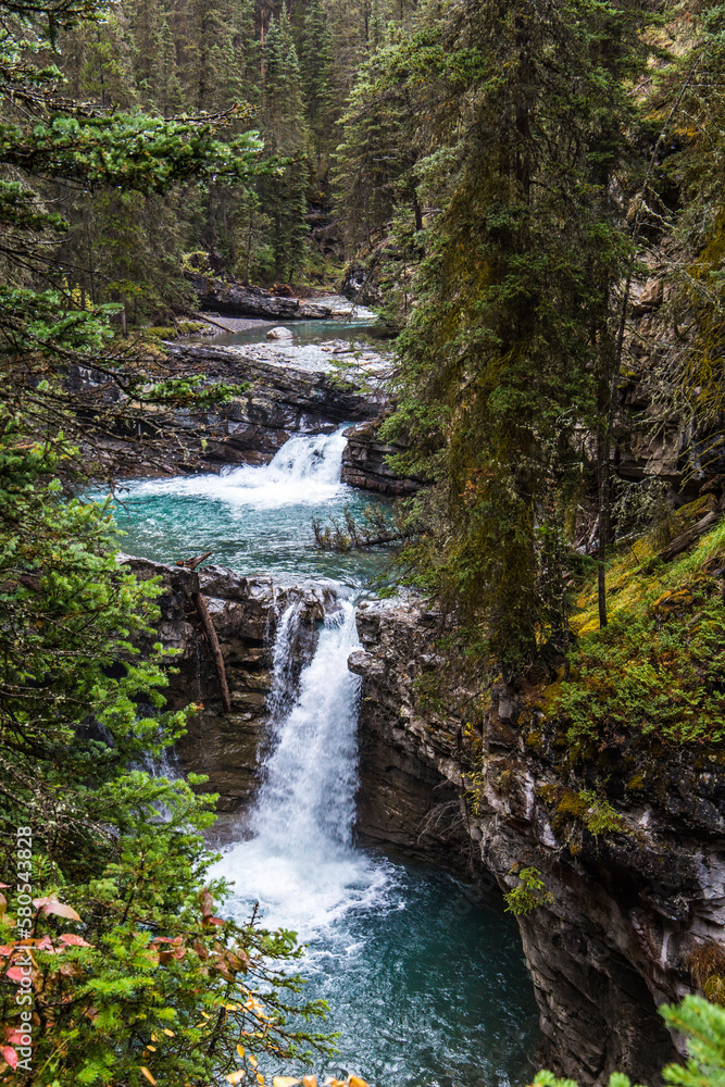 High angle view of waterfalls amidst forest at Banff National Park High angle view of waterfalls amidst forest at Banff National Park