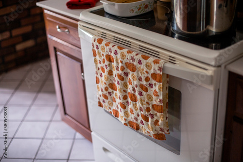 Close-up of dish towel against oven in kitchen at home photo