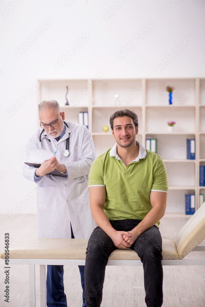 Young male patient visiting old male doctor Young male patient visiting old male doctor